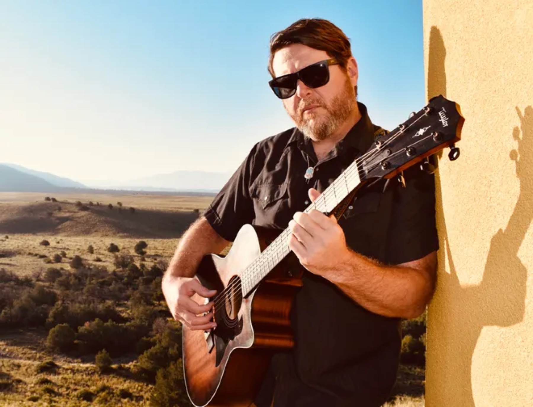 Desert Mind musician performing guitar outdoors in New Mexico
