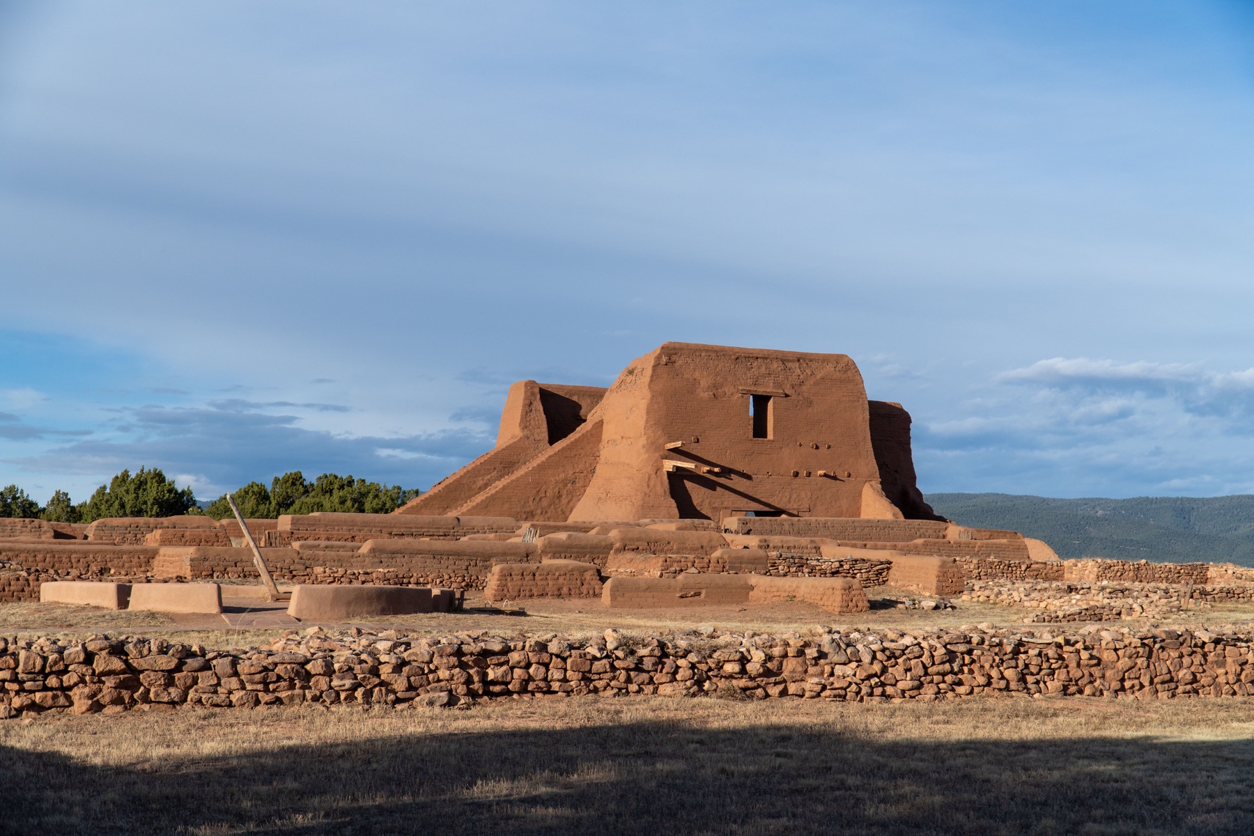 Adobe pueblo architecture beneath a wide Southwestern sky