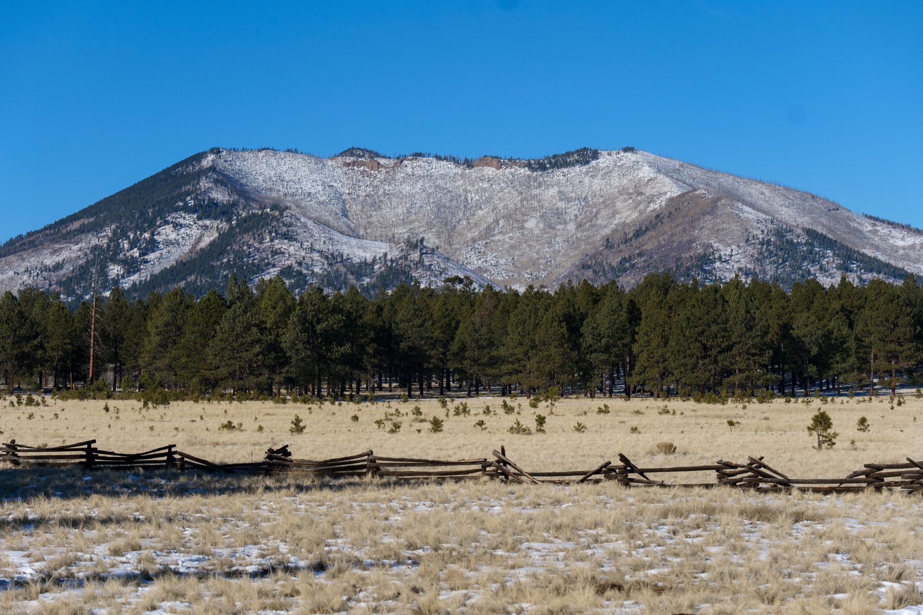 Snowy mountain range and high-desert terrain in northern New Mexico